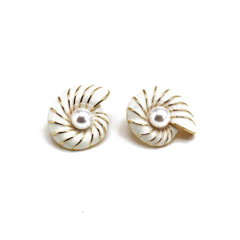 Clip on 1 1/4" gold and white shell earrings with center white pearl