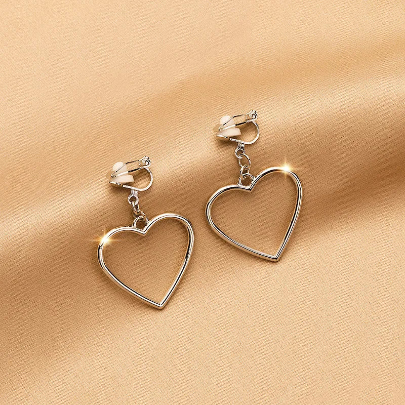 Vintage 1 1/2" clip on shiny silver dangle heart earrings