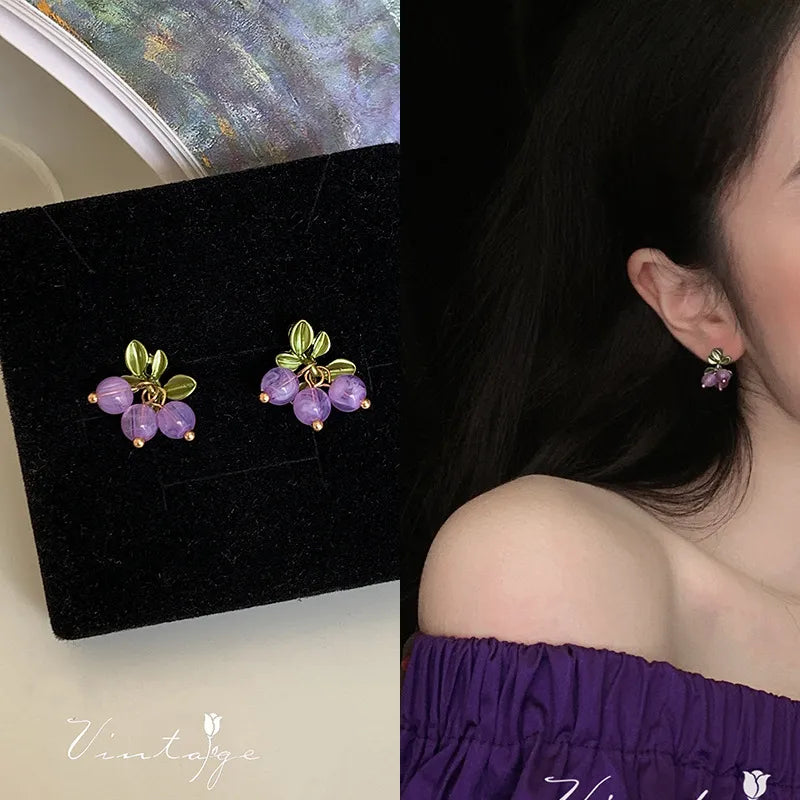 Clip on 3/4" small gold flower earrings with purple dangle beads