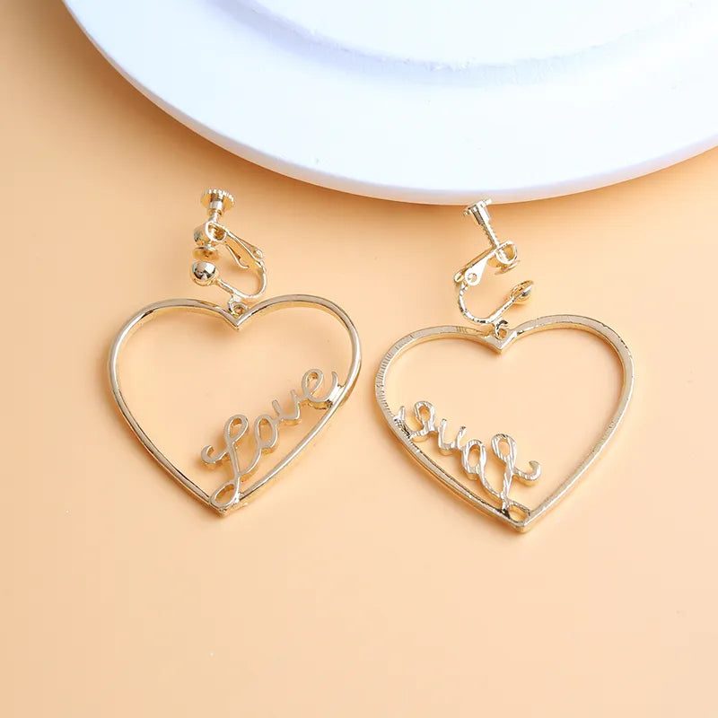Clip on 1 3/4" gold dangle heart earrings with LOVE written inside