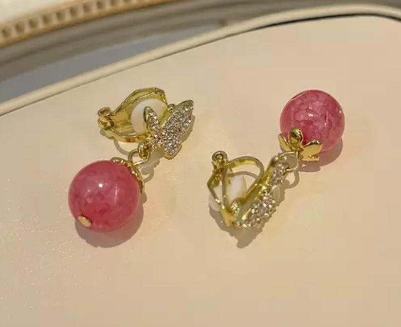 Clip on 1 1/4" gold butterfly and pink bead earrings w/clear stones
