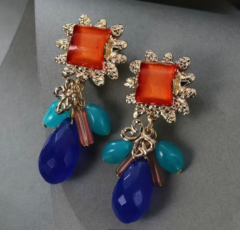 Clip on 2 3/4" gold, orange, multi colored bead earrings with dangle beads