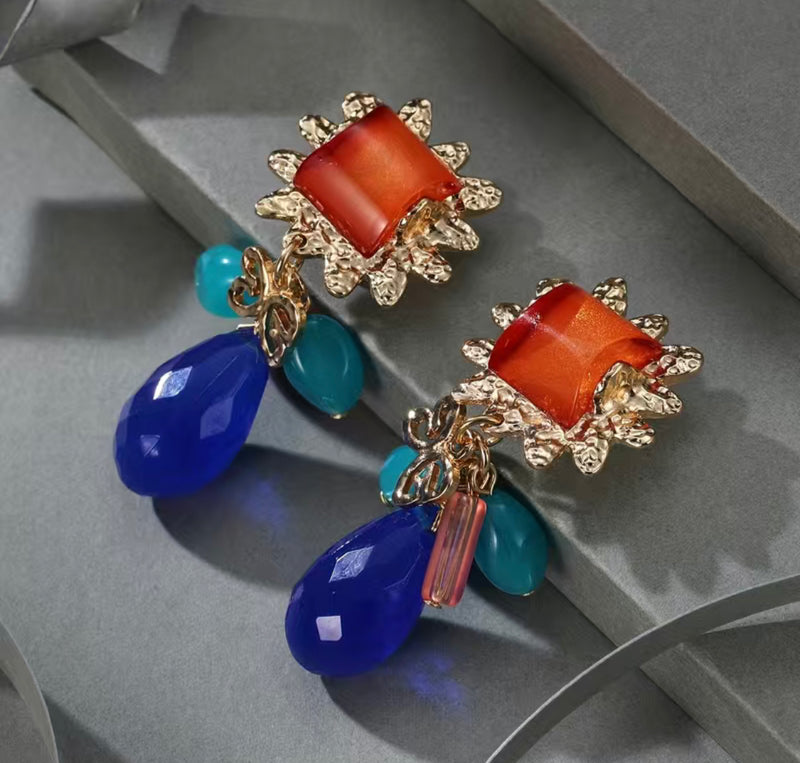 Clip on 2 3/4" gold, orange, multi colored bead earrings with dangle beads