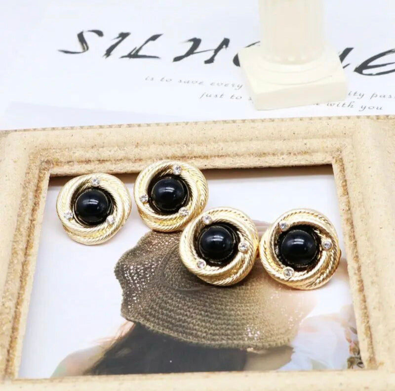 Clip on 1" gold twisted edge black stone button style earrings