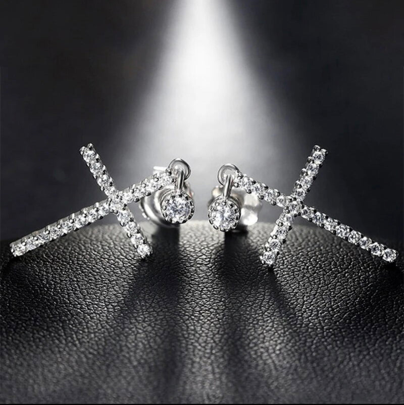 Pierced 1 1/2" silver and clear stone dangle cross earrings