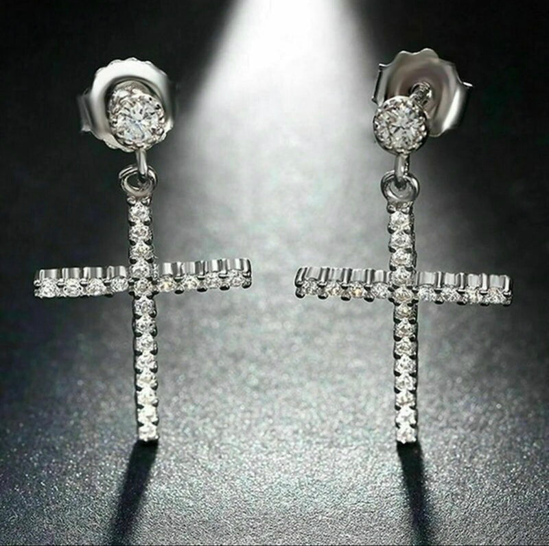 Pierced 1 1/2" silver and clear stone dangle cross earrings