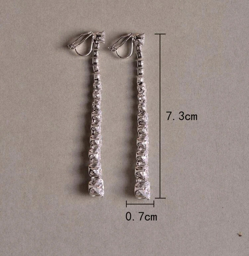 Clip on 3" silver and clear stone graduated stick style earrings