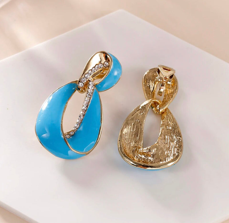 Clip on 1 3/4" gold and white earrings with clear stones