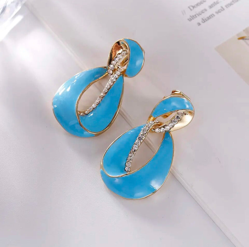 Clip on 1 3/4" gold and blue earrings with clear stones
