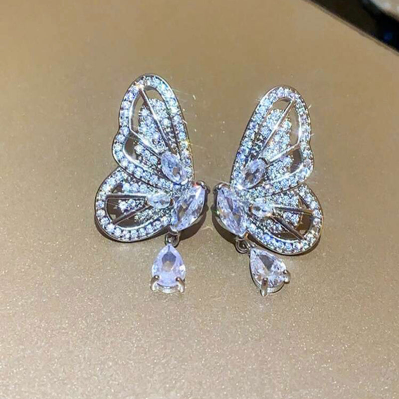Pierced 1 1/2" silver and clear stone butterfly wing dangle earrings