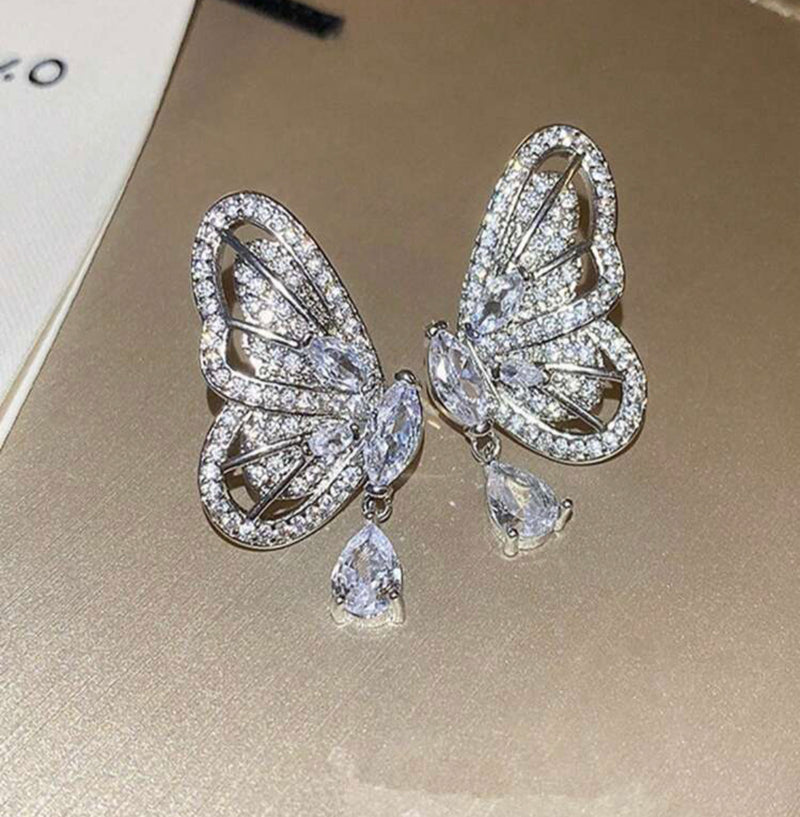 Pierced 1 1/2" silver and clear stone butterfly wing dangle earrings