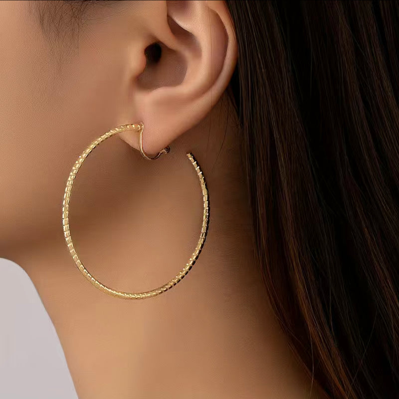 Clip on 2" gold lightweight indented open back hoop earrings