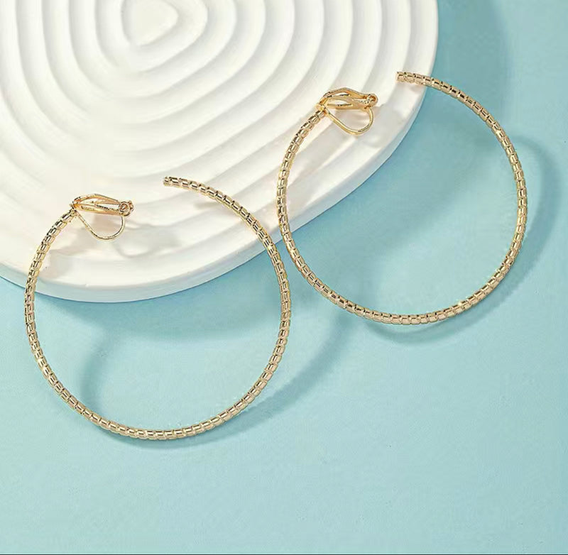 Clip on 2" gold lightweight indented open back hoop earrings