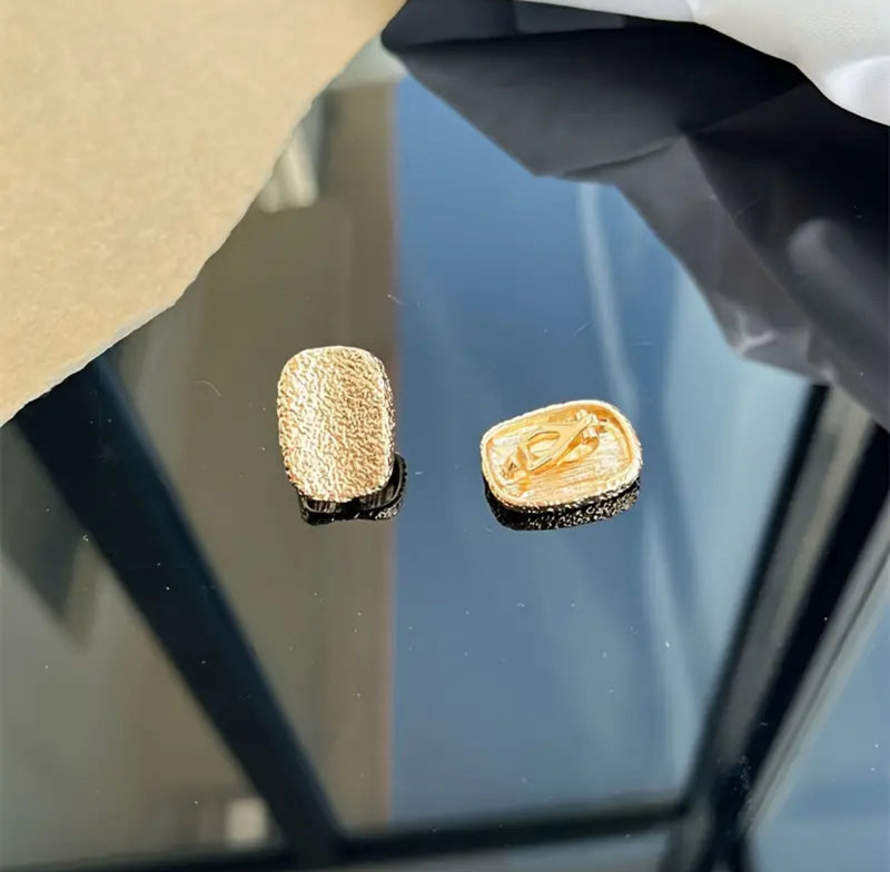 Vintage clip on 1" gold, black and white swirl button style earrings