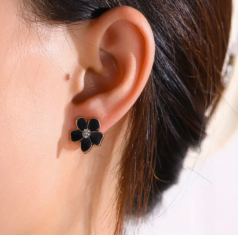 Clip on 1/2" small gold and black flower earrings with center clear stones