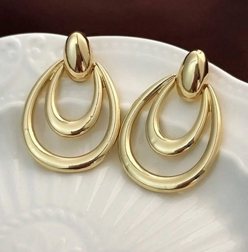 Pierced 1 1/2" shiny gold cutout teardrop dangle earrings