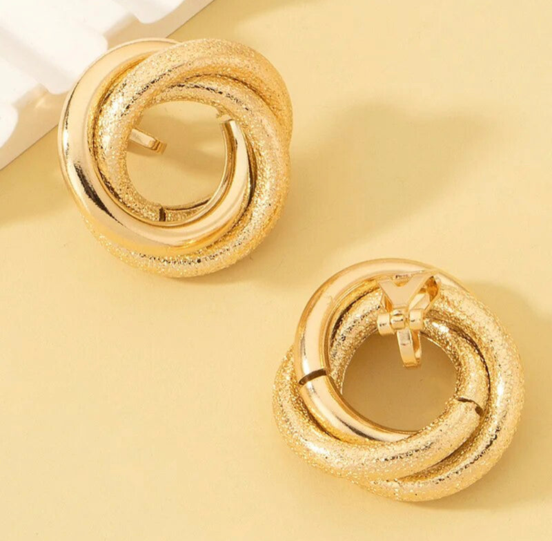 Clip on 1" shiny and textured gold circle knot button earrings