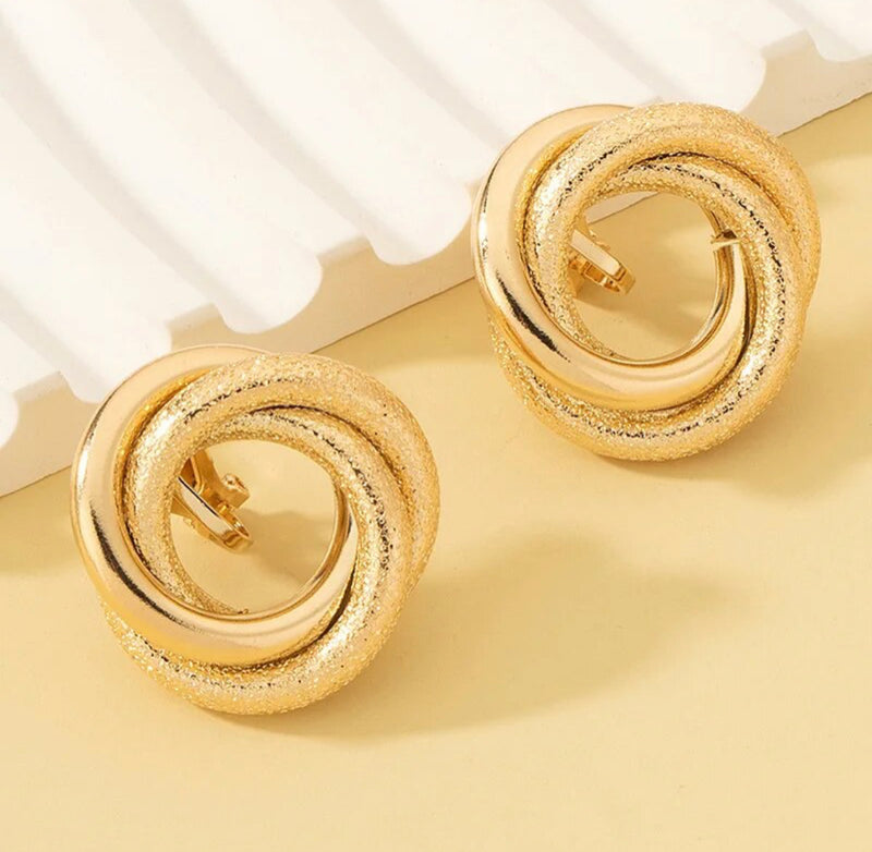 Clip on 1" shiny and textured gold circle knot button earrings