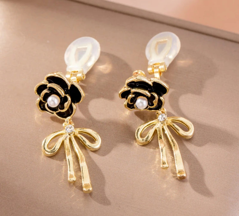 Clip on 1 1/2" gold and black flower earrings with dangle bow and pearl