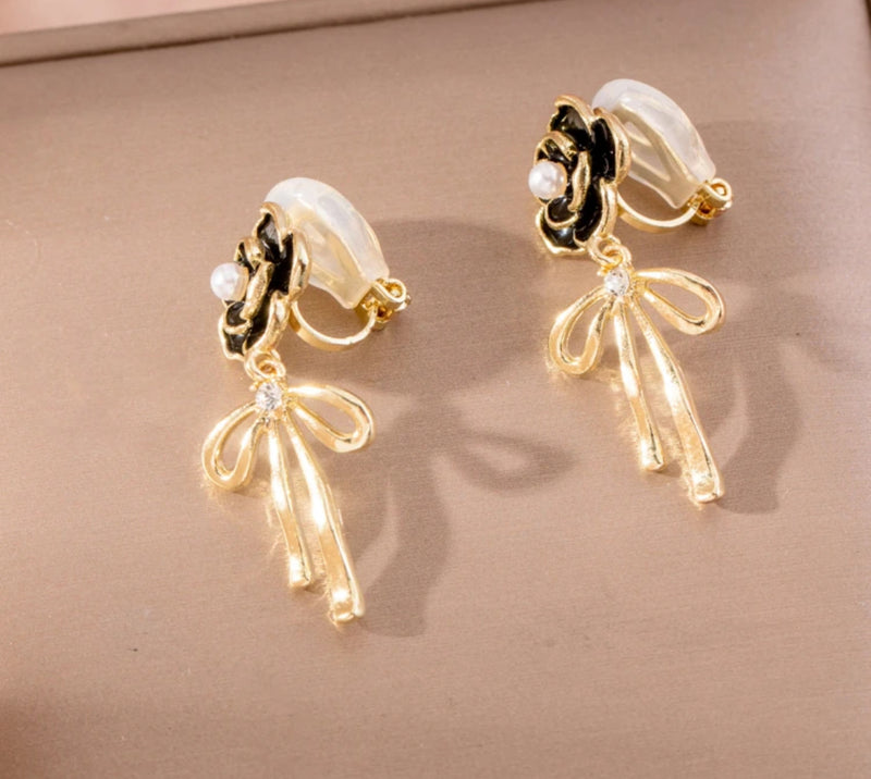 Clip on 1 1/2" gold and black flower earrings with dangle bow and pearl