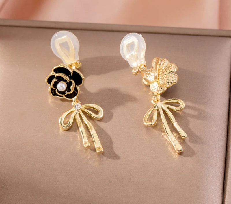 Clip on 1 1/2" gold and black flower earrings with dangle bow and pearl