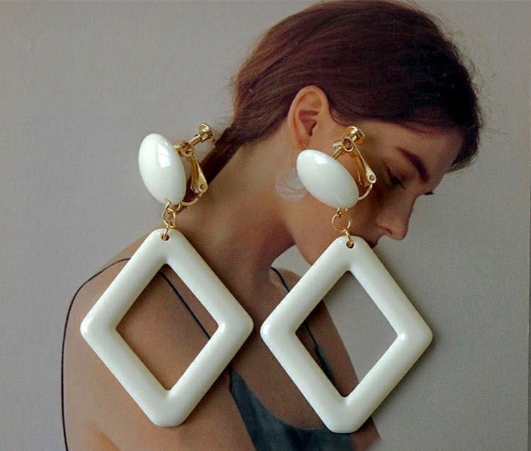 Clip on 2 1/2" gold and cream plastic dangle cutout earrings