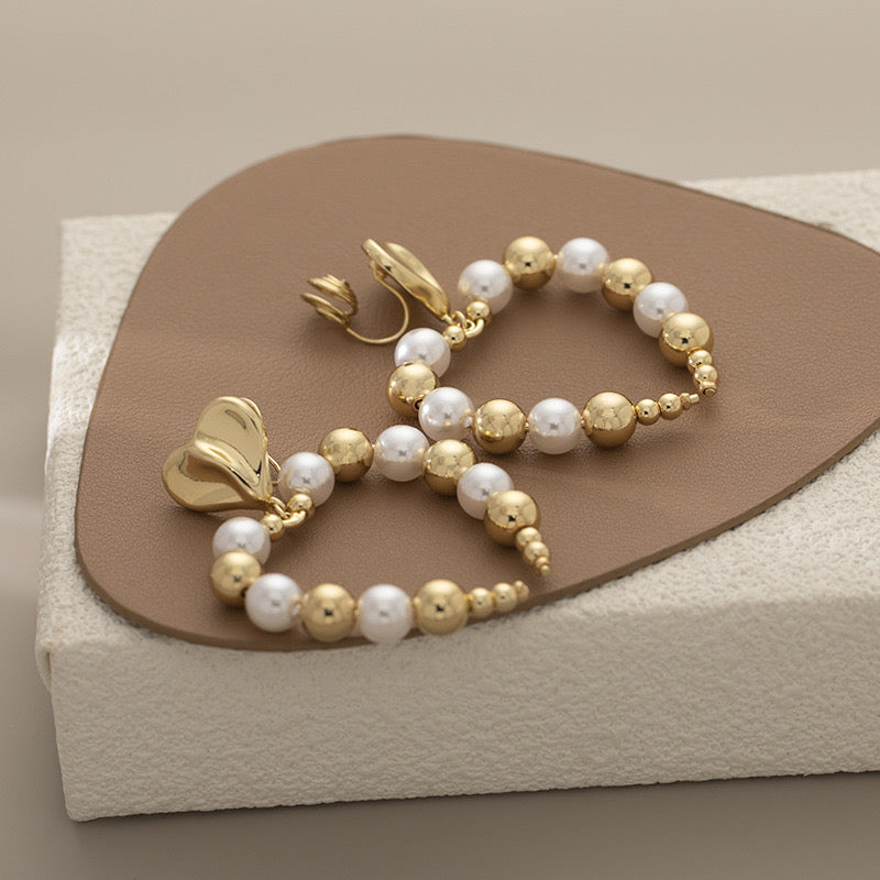 Clip on 2 1/2" lg comfort fit coil gold & pearl pinched heart earrings