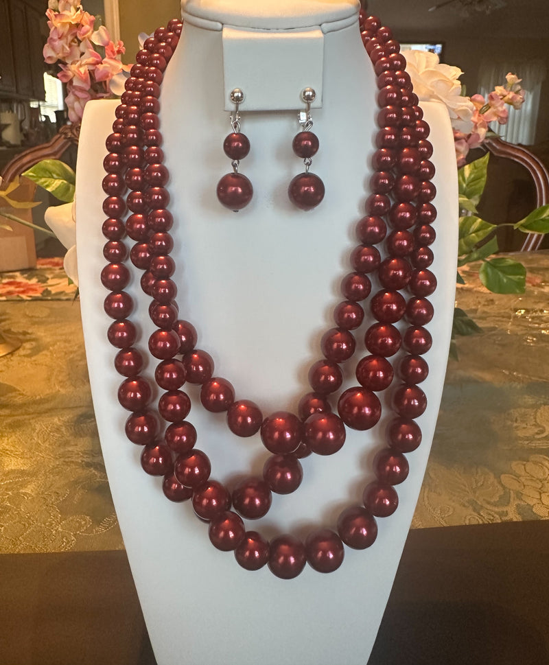 Clip on silver and dark red bead three strand necklace and earring set