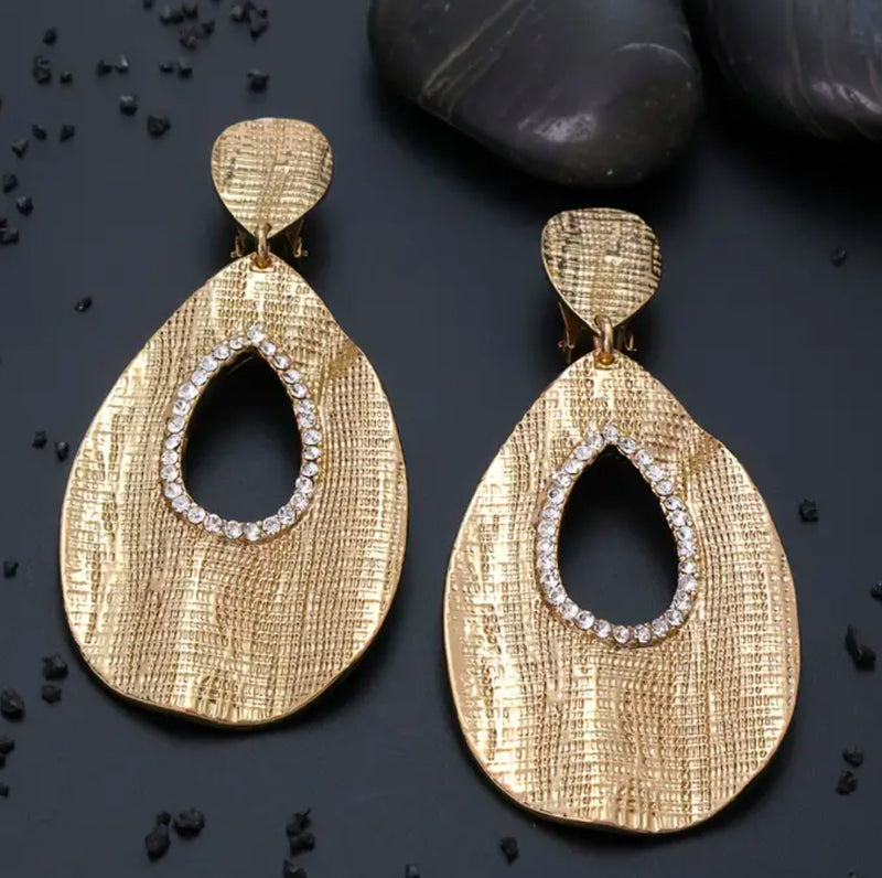 Clip on 3 1/4" gold textured dangle teardrop earrings with clear stones