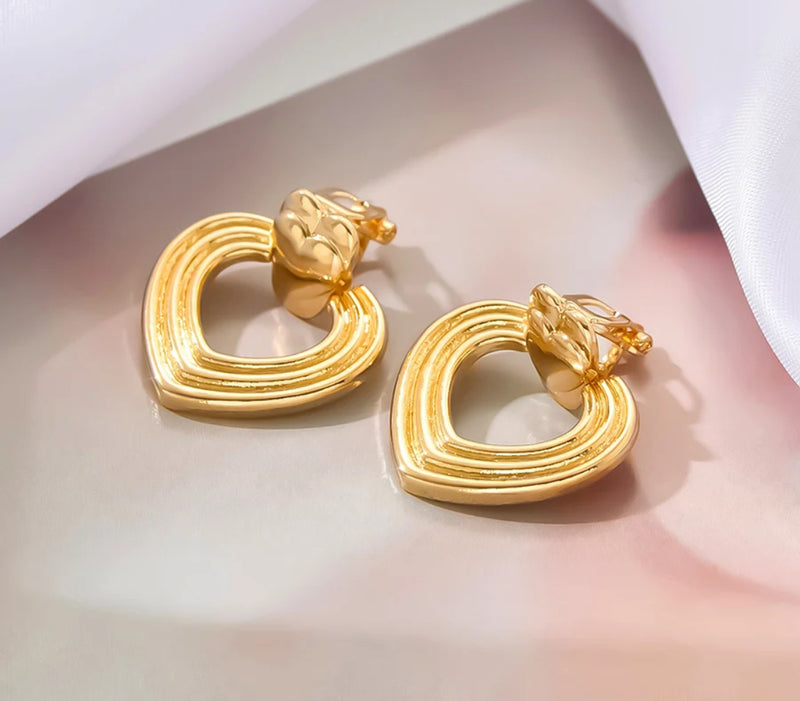 Clip on 1 1/4" shiny gold indented layered heart earrings