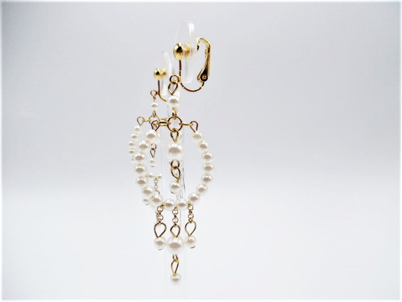 Clip on 3 1/4" long gold and white pearl dangle earrings