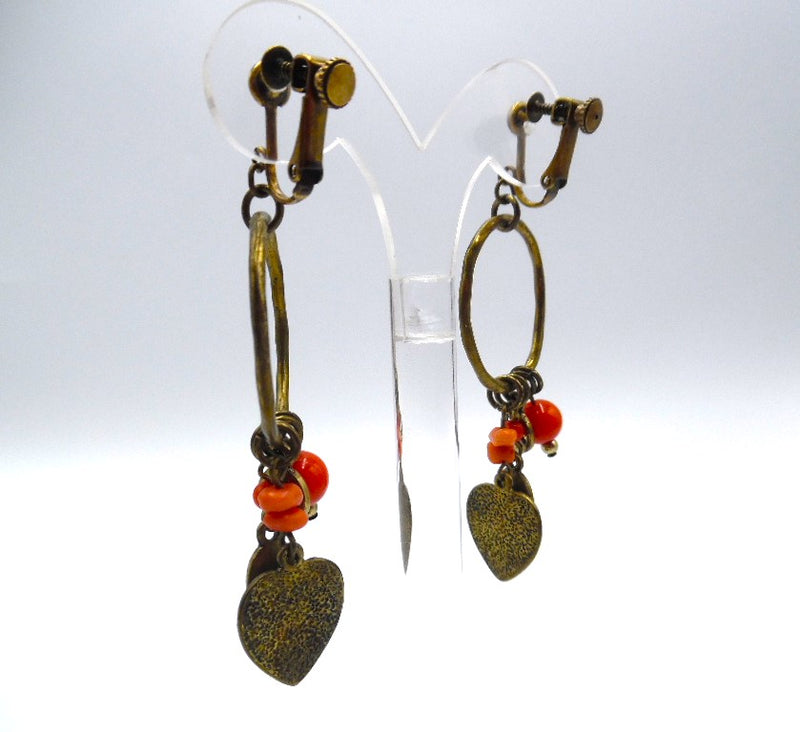 Clip on 3 1/4" brass hoop heart earrings with dangle orange beads