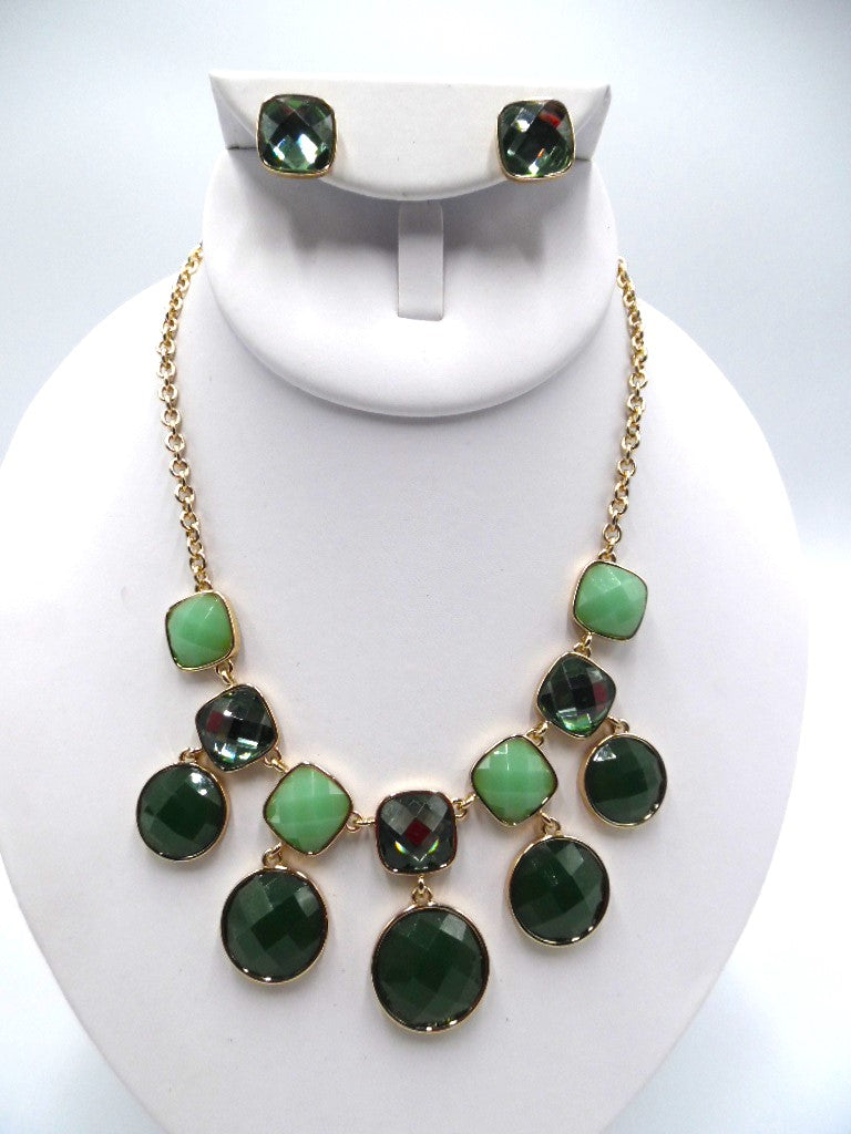 Pierced gold and green stone necklace and earring set