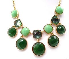 Pierced gold and green stone necklace and earring set