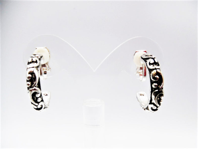 Clip on 1" silver and black raised design open back hoop earrings