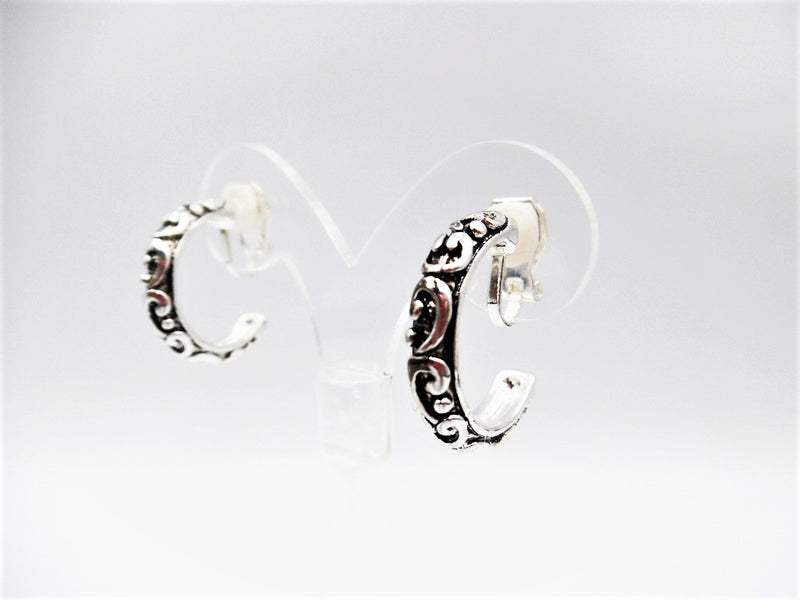 Clip on 1" silver and black raised design open back hoop earrings
