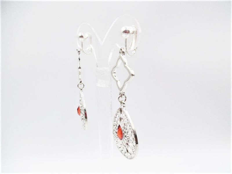 Clip on 2 3/4" silver long cutout teardrop earrings with center red bead