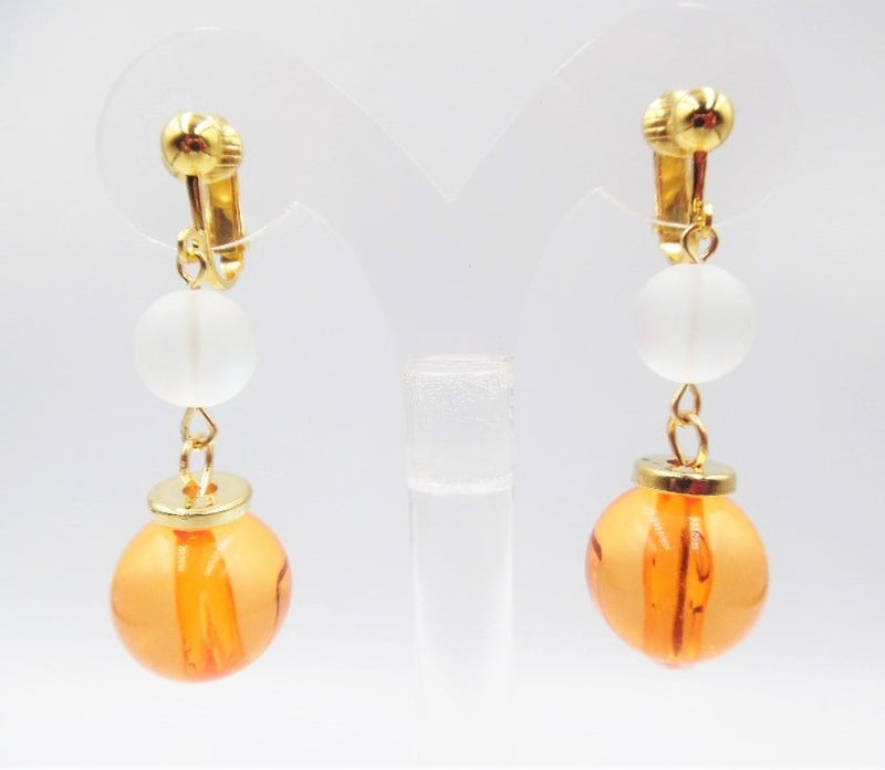 Clip on 2" gold, white frost and orange bead dangle earrings