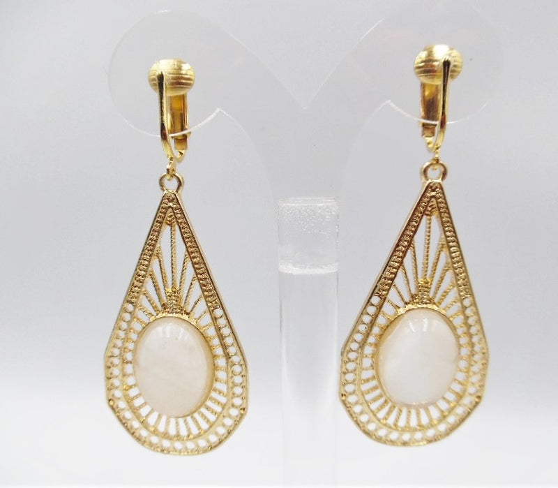 Clip on 2 3/4" gold cutout earrings with white oval center stone