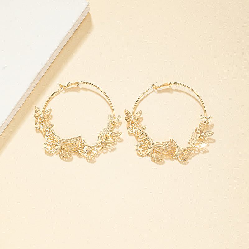DSN Pierced gold hoop earrings with bottom butterflies