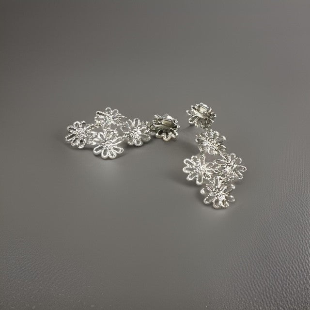 Clip on 2 1/2" silver layered cutout flower dangle earrings