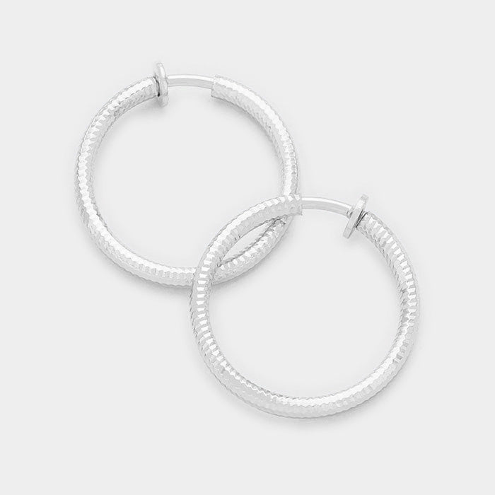Clip on 1 1/4" silver indented twisted spring back hoop earrings