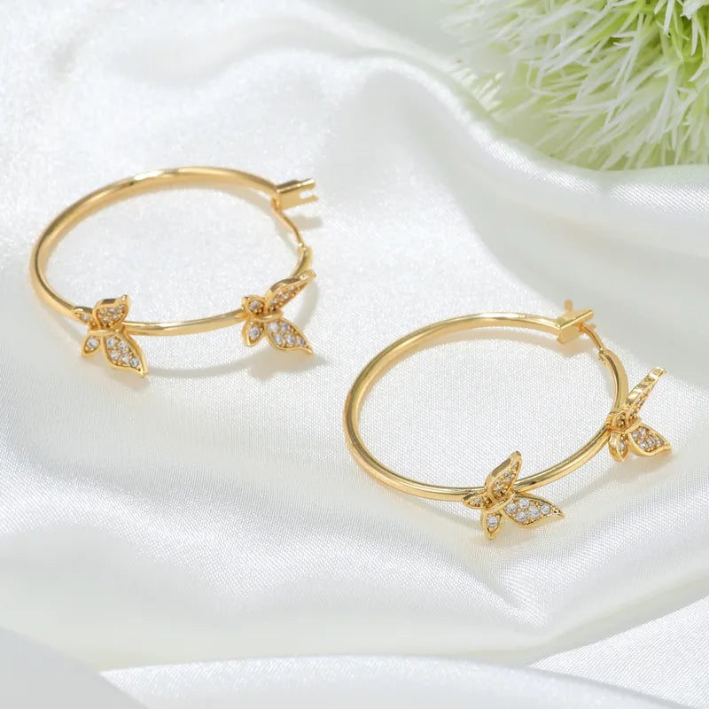 Pierced 1 1/4" gold and clear stone butterfly hoop earrings