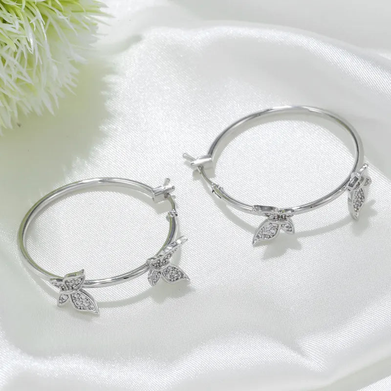 Pierced 1 1/4" silver and clear stone butterfly hoop earrings