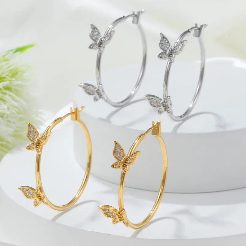 Pierced 1 1/4" gold and clear stone butterfly hoop earrings