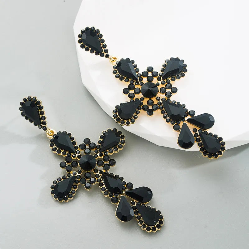 Pierced 3 3/4" long gold and black stone cross dangle earrings