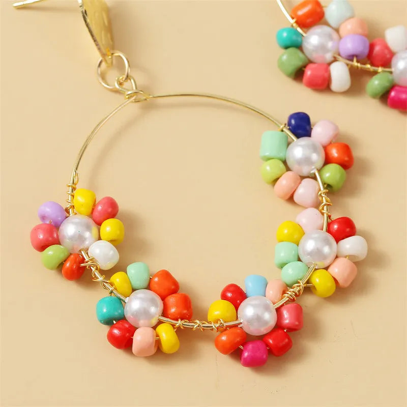 Pierced gold wire hoop earrings with multi colored or yellow beads & pearl