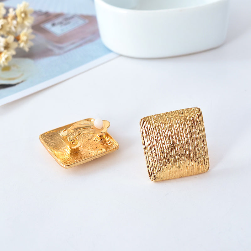 Clip on 1" gold textured square button style earrings