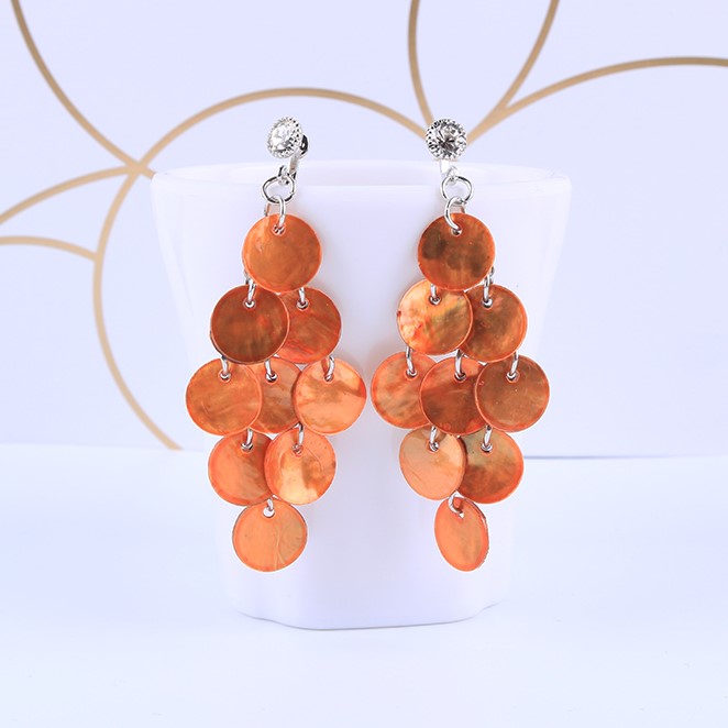 Clip on 2 3/4" silver and round layered orange shell earrings with clear stone