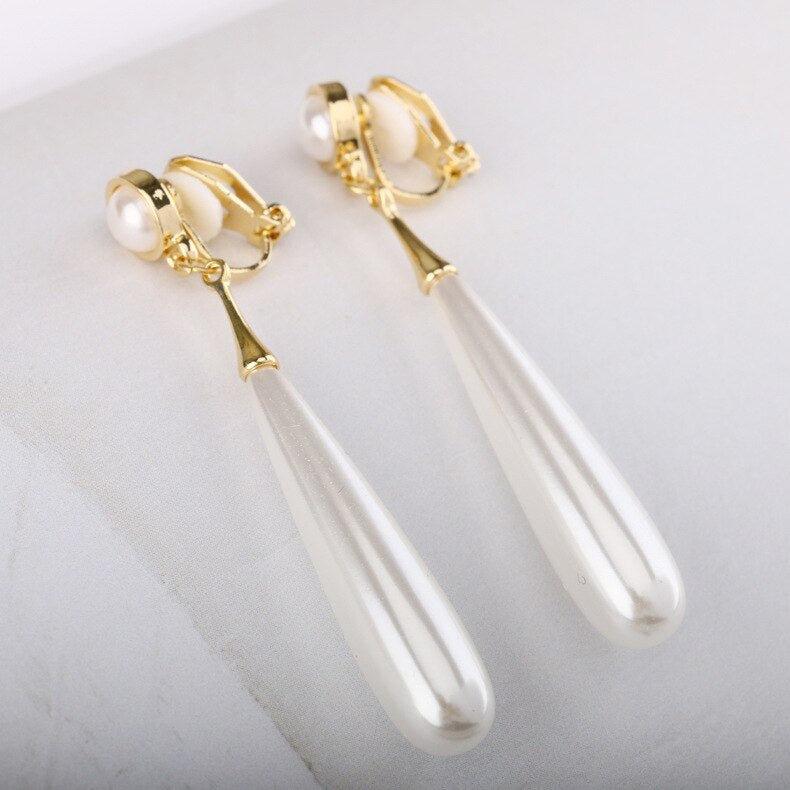 Clip on 1" gold, blue oval stone earrings with pearls and clear stones